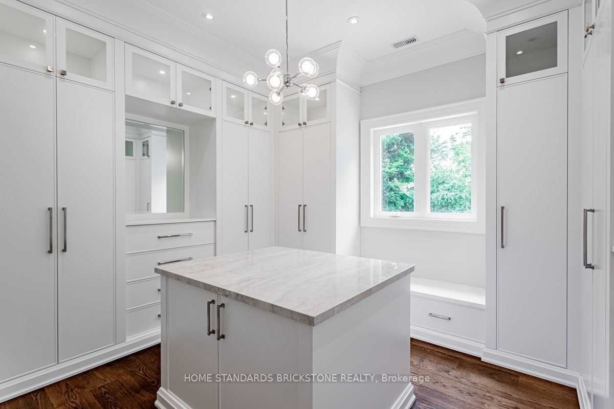 Walk-in dressing room with floor-to-ceiling custom wardrobes